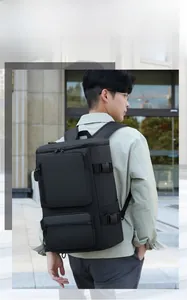 Large black travel backpack with side buckles and multiple compartments on male model