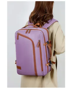 Macro detail of purple travel backpack showing waterproof fabric and side leather handle