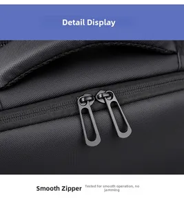 Close-up of smooth dual metal zippers on water-resistant black expansion backpack