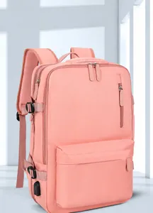 Detail view of pink travel backpack featuring exterior USB charging port and side buckles