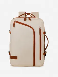 Front view of beige travel backpack with brown leather accents and multi-zipper compartments
