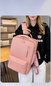 Pink waterproof travel backpack with multiple compartments and side buckles detail view
