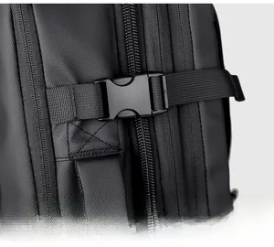 Close-up of side buckle and reinforced stitching on a black waterproof backpack