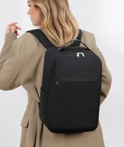 Rear view of model wearing minimalist black waterproof business travel laptop backpack