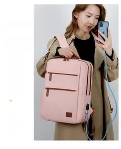 Pink waterproof nylon laptop backpack with USB charging port and brown leather pullers