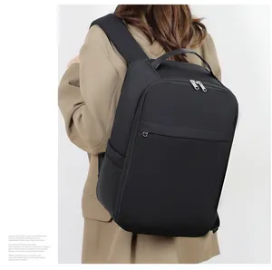 Side view of black business laptop backpack with silver zippers on male model