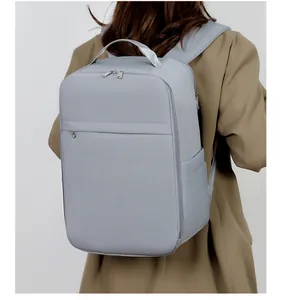 Detail of gray waterproof fabric business backpack on a model in a khaki blazer