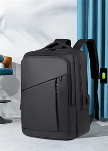 Detail of waterproof black business backpack showing external USB charging port and zipper