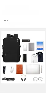 Flat lay of a large capacity travel backpack with organized compartments and daily essentials