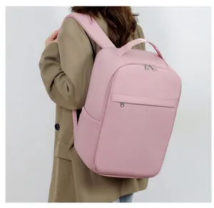 Detail view of pink laptop backpack worn by a model in professional business attire