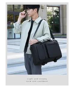 Detail of a large black multifunctional bag with front zipper pockets and adjustable strap