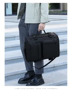 Detailed view of black multi-functional travel bag with tactical buckles on stone stairs