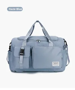 Dettaglio borsa da viaggio blu nebbia con doppi manici e tasca frontale con fibbia