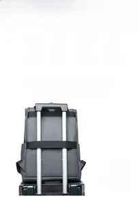 Detail of grey travel backpack showing waterproof material and luggage trolley strap