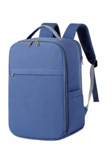 Detail view of the wide breathable shoulder straps and top handle on a blue laptop backpack