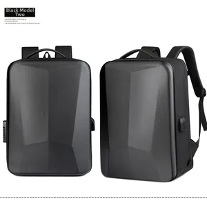 Close-up of geometric hardshell backpack featuring external USB charging port and sleek black finish