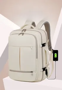 Detail showing the external USB charging port of a cream business laptop backpack