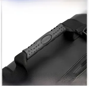 Detail of the thickened rubber top handle with non-slip texture on a black travel bag