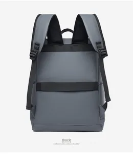 Deep gray travel backpack back view with padded straps and luggage trolley strap