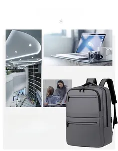 Detail of dark grey business backpack featuring a built-in USB charging port and zipper pockets