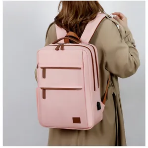 Pink business laptop backpack with USB charging port shown on female model