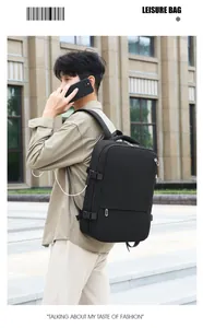 Close-up of black travel backpack showing side compression buckle and USB charging port