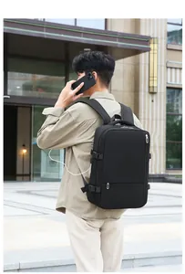 Close-up of black travel backpack showing side USB charging port and buckles