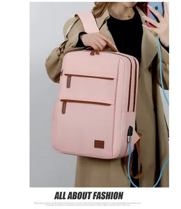 Detail of pink laptop backpack showing side USB charging port and waterproof nylon texture