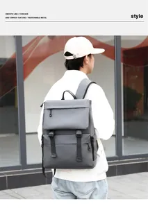Outdoor shot of a grey water-resistant backpack showing buckles and front zipper pocket