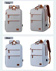 Detail view of business backpack showing USB charging port and brown leather accents