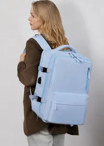 Detail view of light blue travel backpack with USB charging port and side buckle strap