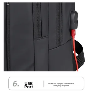 Detail of integrated external USB charging port on black water-resistant backpack fabric
