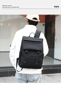 Man wearing a large black waterproof business backpack with buckle closure in urban setting