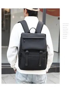Detail of waterproof black travel backpack showing adjustable buckles and side zipper pockets