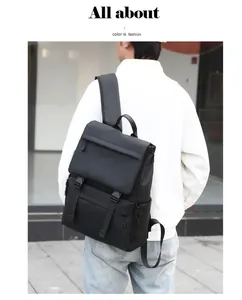 Outdoor shot of a man wearing a large black travel backpack with buckle flap design