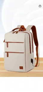Detail of laptop backpack showing external USB charging port and brown leather trim accents