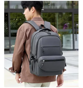 Side view of gray water-resistant laptop backpack showing multi-zippered compartments