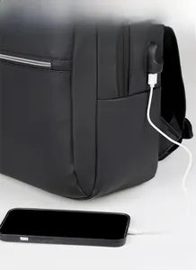 Detail showing the integrated USB charging port on a black business laptop backpack