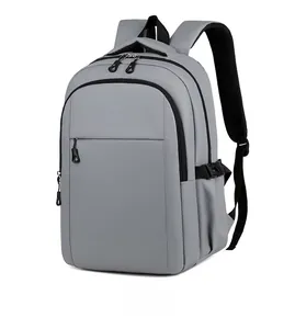 Detail view showing dual-zipper compartment and breathable mesh straps of grey backpack