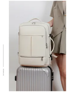 Close-up of beige travel backpack with multiple functional pockets on silver suitcase