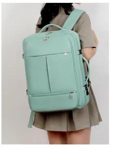 Side view of a mint green multi-compartment large capacity business commute backpack