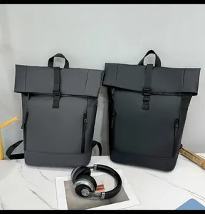 Front view of charcoal grey and black roll-top backpacks with vertical zippers and buckle
