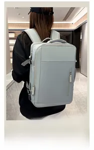 Rear view of model wearing a large grey business backpack with waterproof fabric