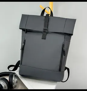 Close-up of waterproof grey roll-top backpack with dual vertical zipper pockets