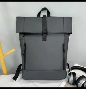 Detail of waterproof dark grey roll-top backpack with vertical zippers and buckle closure