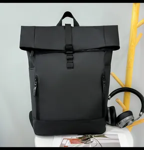 Macro detail of waterproof black roll-top backpack with symmetric vertical zipper pockets
