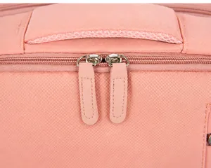 Macro detail of high-gloss hardware zipper on pink travel backpack with premium stitching