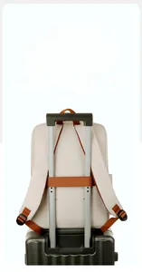 Detail of beige backpack featuring a practical trolley sleeve for luggage attachment