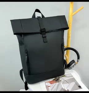 Detail of waterproof matte black roll-top backpack with vertical zippers for urban commute