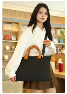Briefcase with orange handles shown in a library setting with detachable shoulder strap